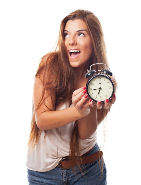 Charming woman with alarm clock in hands