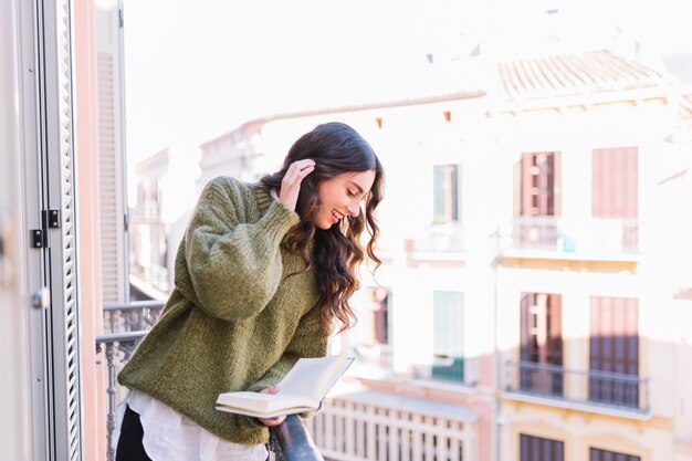 Charming woman with book looking down