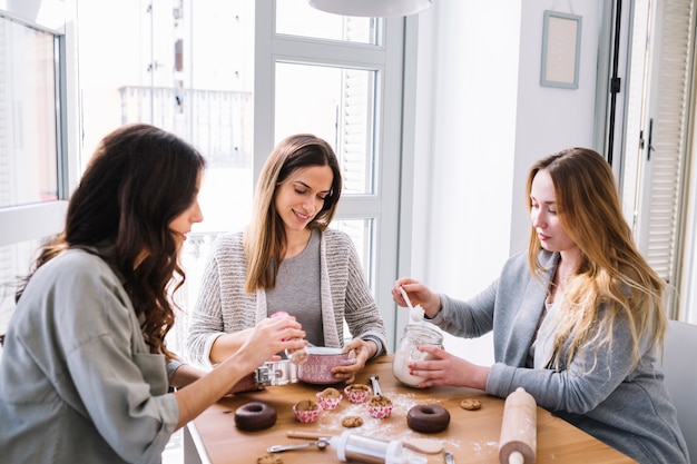 Charming women decorating desserts