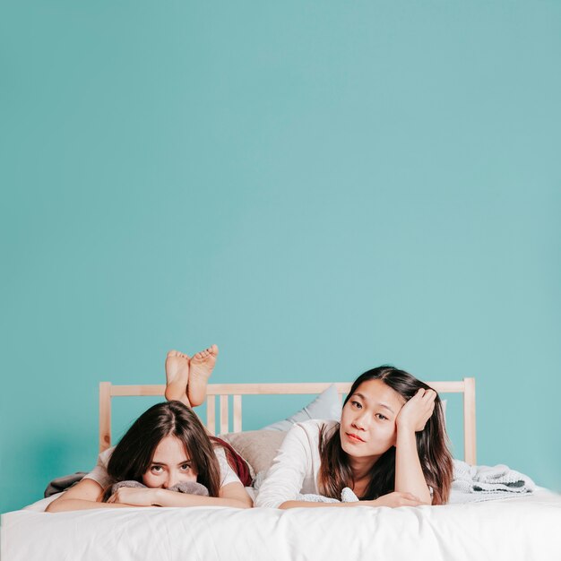 Charming women lying on bed