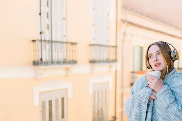 Free photo charming women with cup on balcony