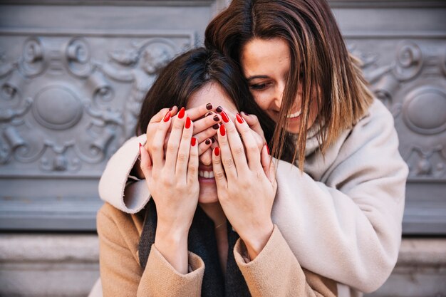 Charming young girlfriends posing playfully