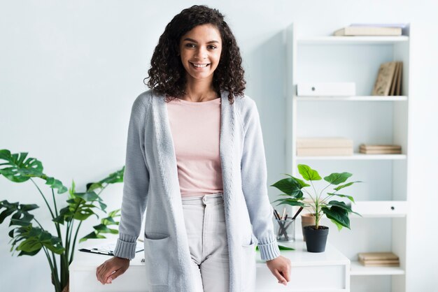 Charming young woman standing in workplace