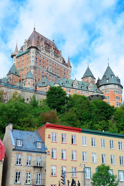 Chateau Frontenac in the day with colorful buildings on street in Quebec City