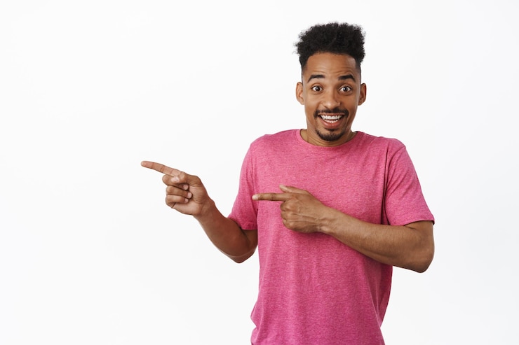 Free Photo check out. happy african american man pointing fingers left at sale logo, showing promo text and smiling cheerful, recommending product, white background