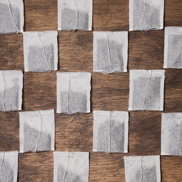 Checkered tea bag on wooden textured background