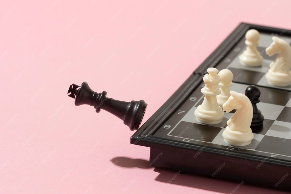 black king kicked of chess board signifying checkmate - the end of the game