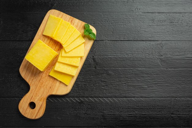 Cheddar Cheese on dark wooden surface