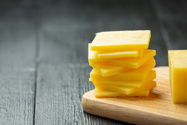 Cheddar Cheese on dark wooden surface