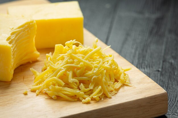 Cheddar Cheese on dark wooden surface