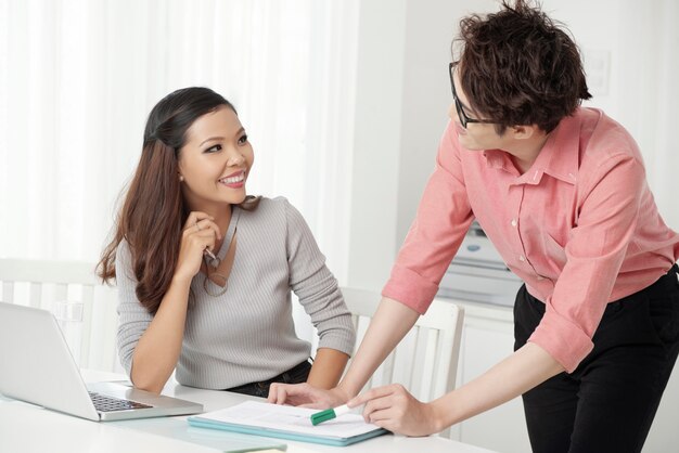 Cheerfu cooperating man and woman in office