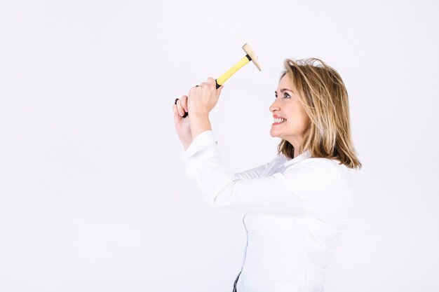 Cheerful adult woman with hammer