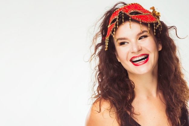 Free photo cheerful adult woman with red carnival mask