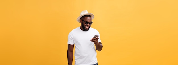 Cheerful african american man in white shirt using mobile phone application happy dark skinned hipst