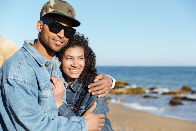 Cheerful african loving couple walking outdoors