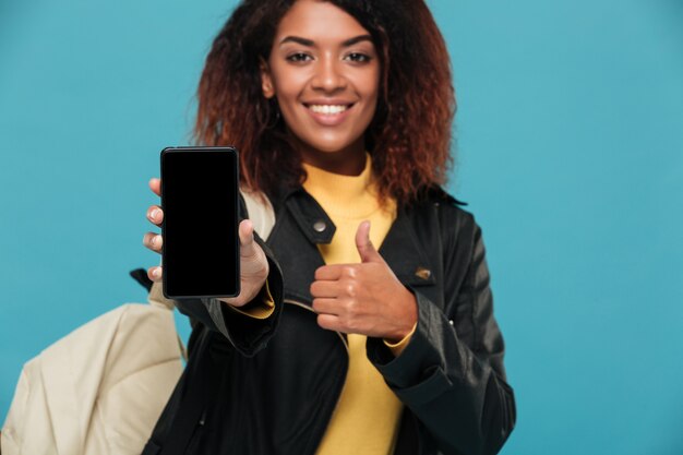 Cheerful african woman student showing display of mobile phone