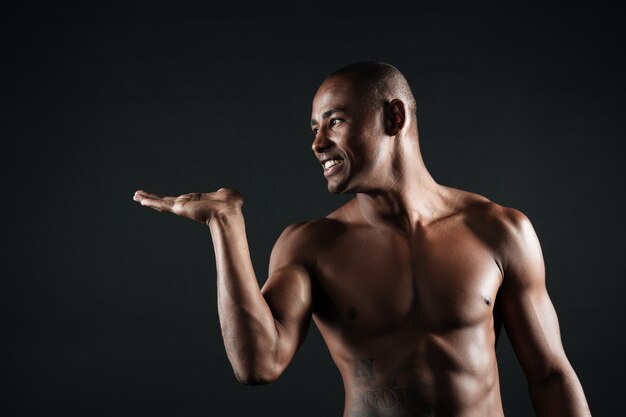 Cheerful afro american sports man sends an air kiss