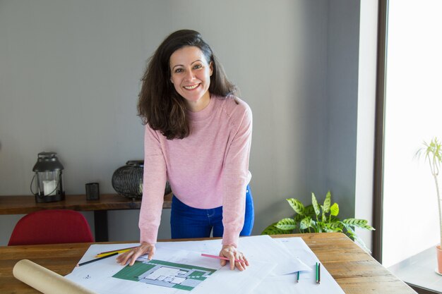 Cheerful architectural designer enjoying work process