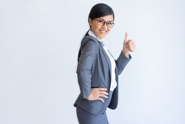 Cheerful Asian business lady recommending product