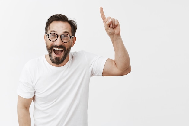 Cheerful attractive bearded mature man with glasses posing