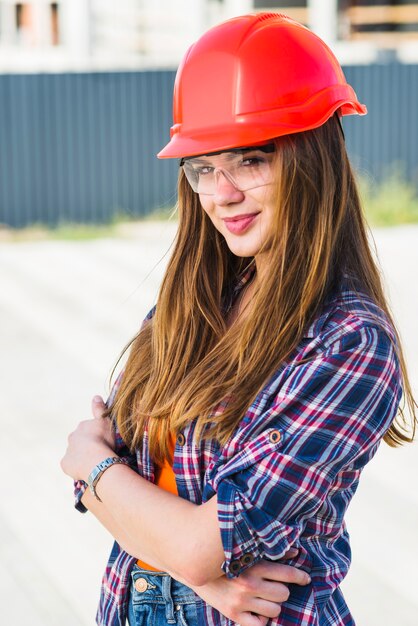 Cheerful attractive builder in hardhat