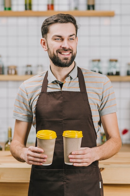 Free photo cheerful bartender with hot beverages