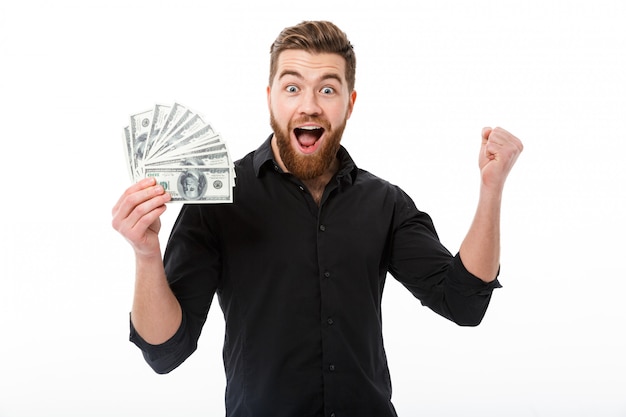 Cheerful bearded business man in shirt holding money