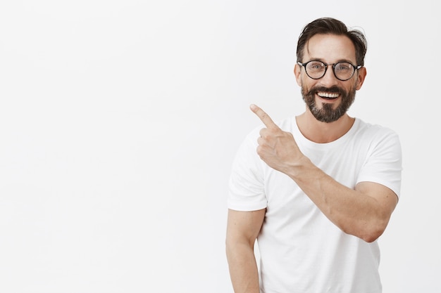 Cheerful bearded mature man with glasses posing