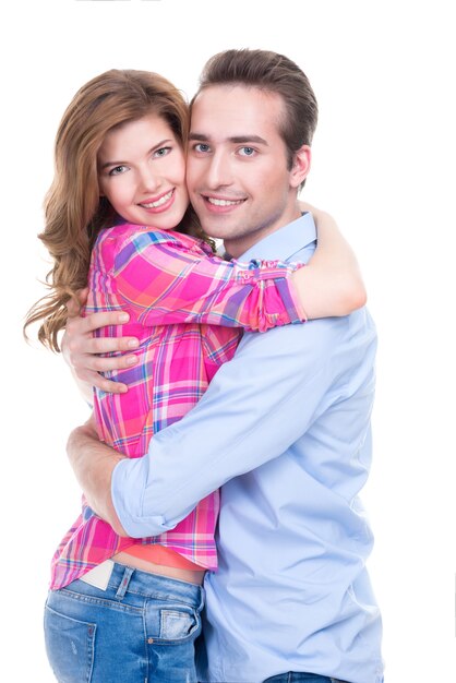 Cheerful beautiful couple in embrace looking at camera