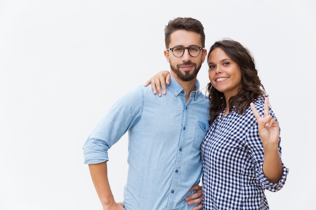 Cheerful beautiful woman hugging boyfriend