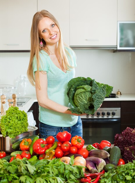 cheerful beautiful woman with raw vegetables