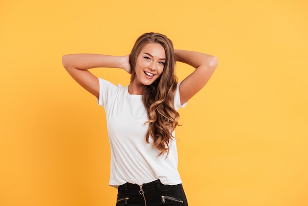 Cheerful beautiful young woman standing and posing isolated