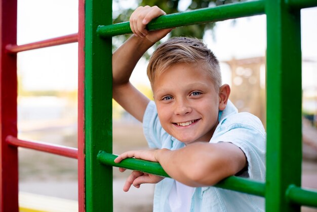 Cheerful boy playing alone at playground