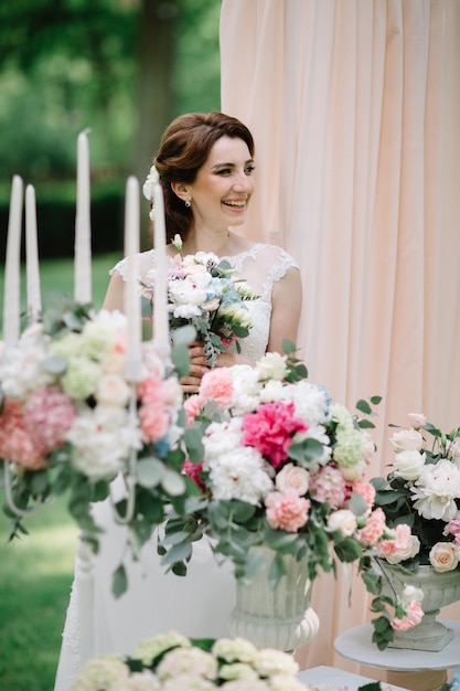 "Cheerful bride among blooming flowers"