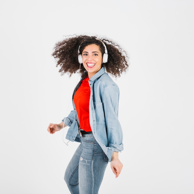 Cheerful brunette in headphones looking at camera