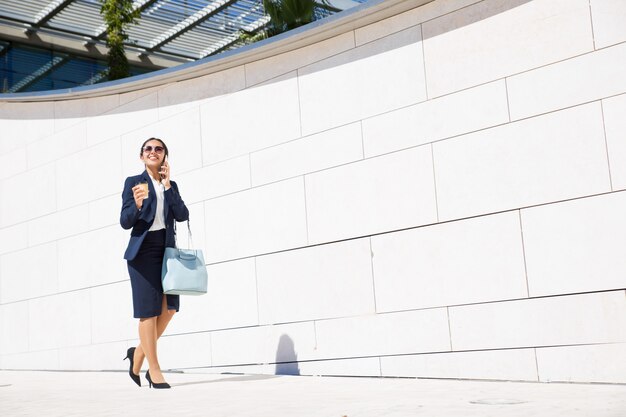 Cheerful business consultant drinking coffee