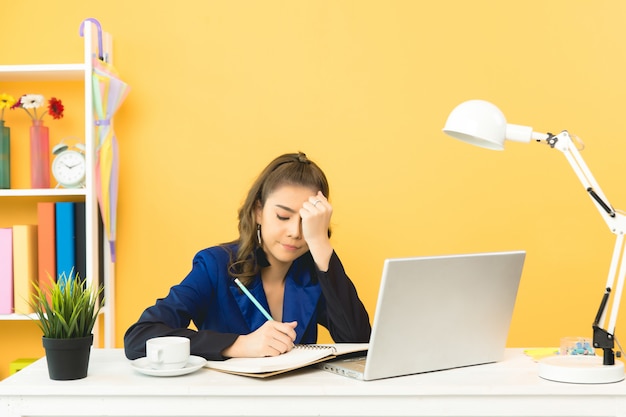 Cheerful business lady working on laptop in office