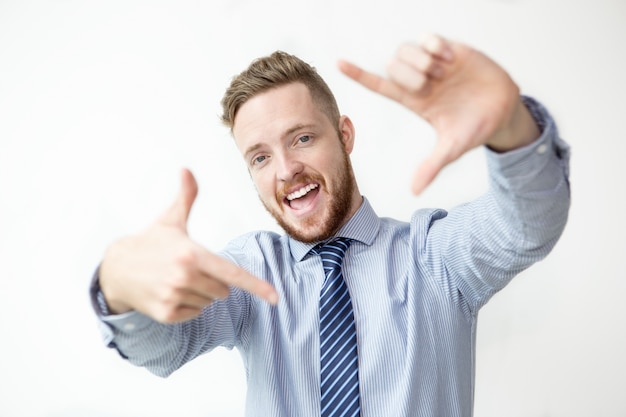 Free photo cheerful business man making frame gesture