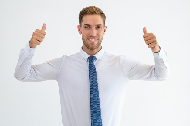 Cheerful business man showing thumbs up and looking at camera