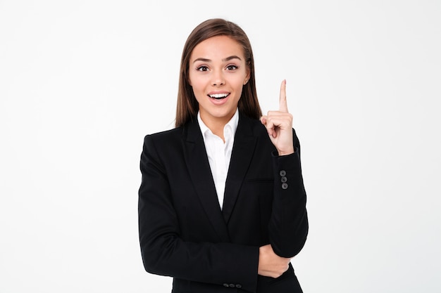 Cheerful business woman pointing to copyspace.