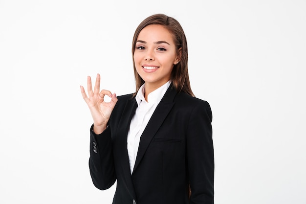 Cheerful business woman showing okay gesture