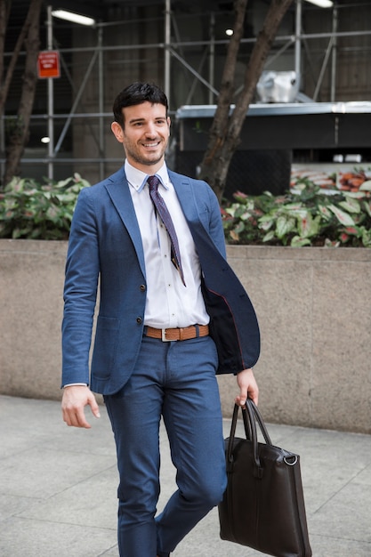 Cheerful businessman walking on street