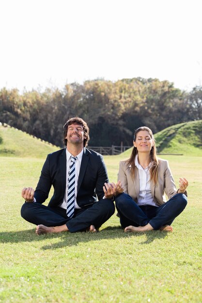 Cheerful businesspeople in the lotus position