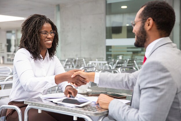 Cheerful businesspeople reaching agreement