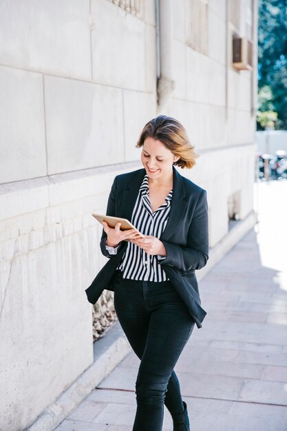 Cheerful businesswoman using tablet