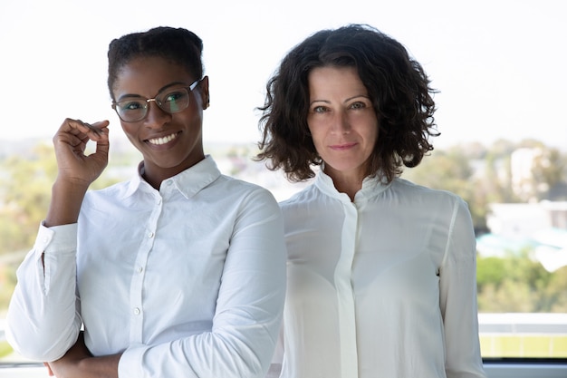 Cheerful businesswomen smiling at camera