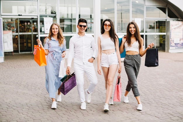 Cheerful buyers with bags