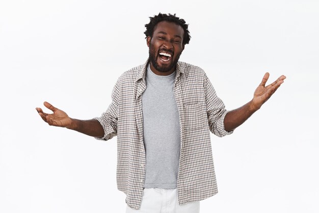 Cheerful, carefree african-american guy with beard in casual shirt, t-shirt