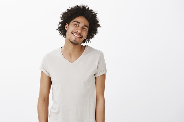 Cheerful carefree dark-skinned man laughing and smiling happy