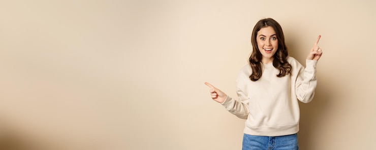 Free Photo cheerful caucasian woman showing directions two ways pointing sideways at variants choices for custo